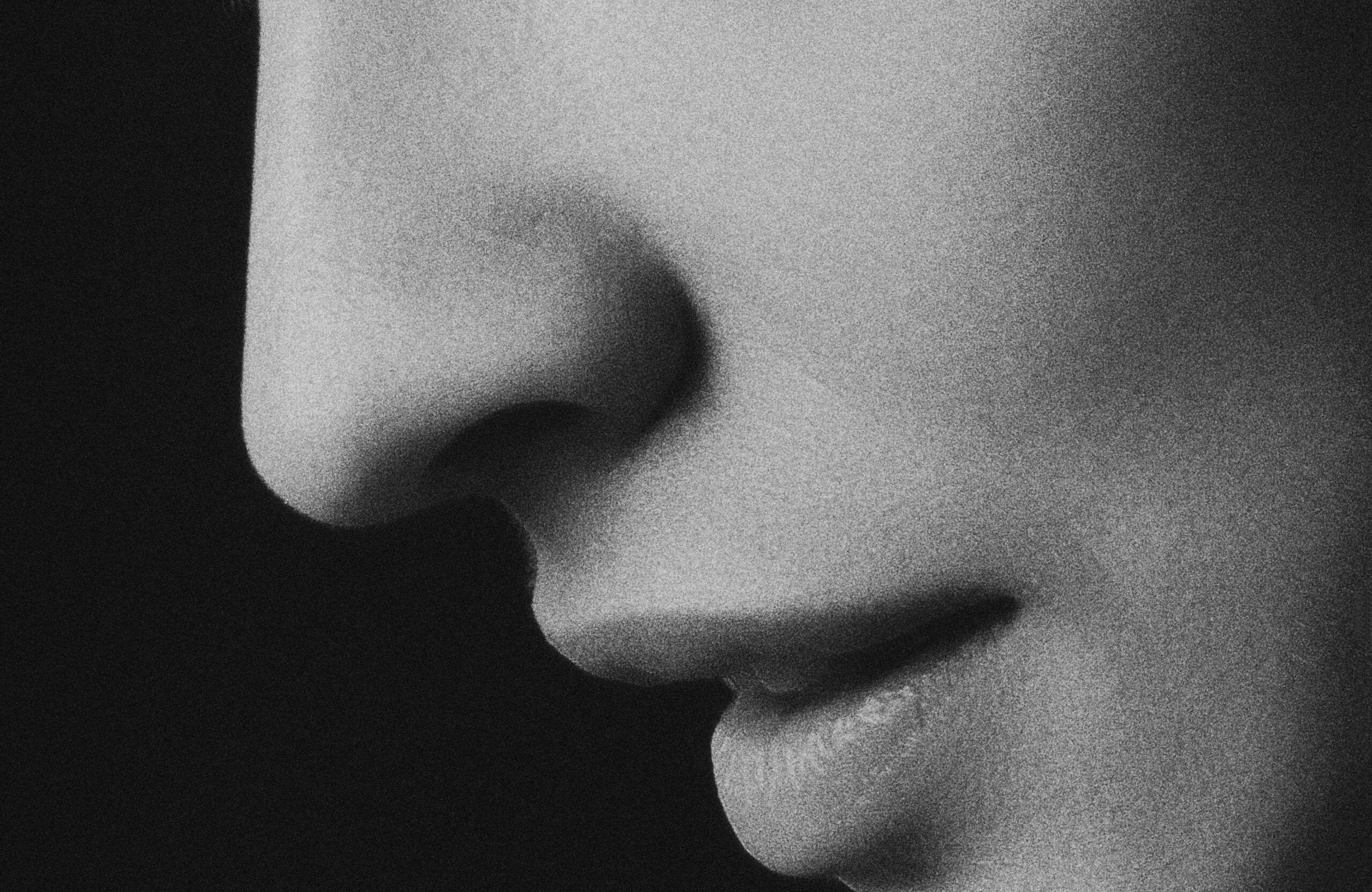black and white photo of woman's nose and lips