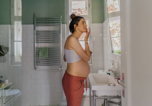 Pregnant woman doing skin care