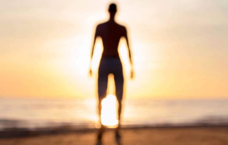 Defocused blurred man phantom silhouette in rays of sunlight