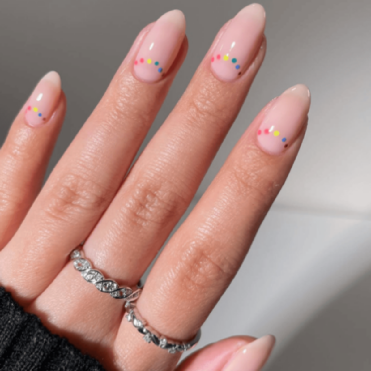 Natural nails with rainbow polka dot design