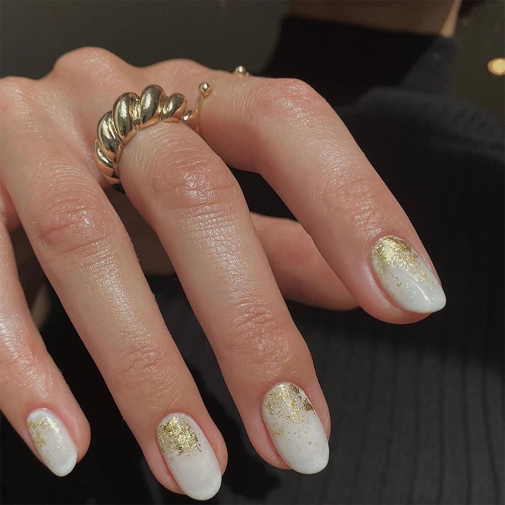 Milky White Gold LeafTry topping nail cuffs with gold foil accents to take your milky white manicure up a notch for Hanukkah.