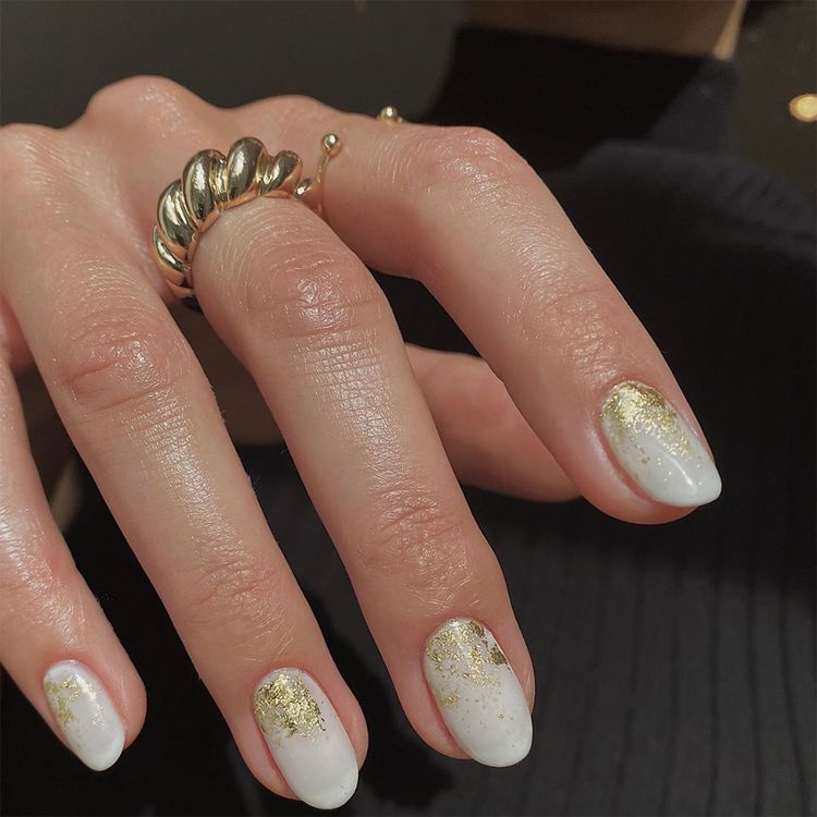 Milky White Gold LeafTry topping nail cuffs with gold foil accents to take your milky white manicure up a notch for Hanukkah.