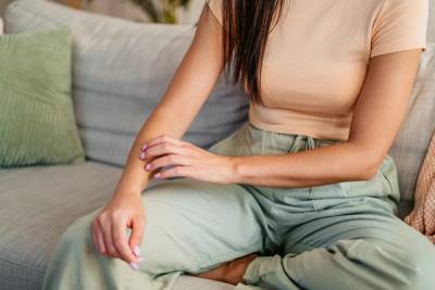 woman scratching her arm