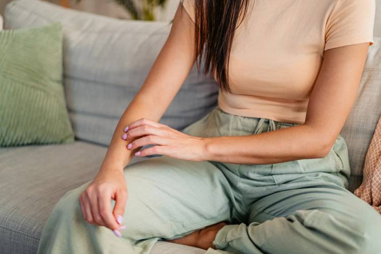 woman scratching her arm