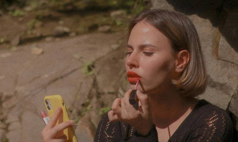 woman applying red lipstick