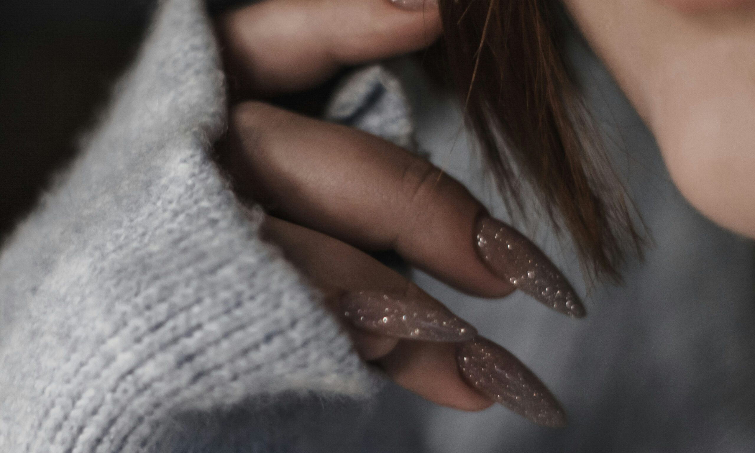 close up of woman's glittery long nails
