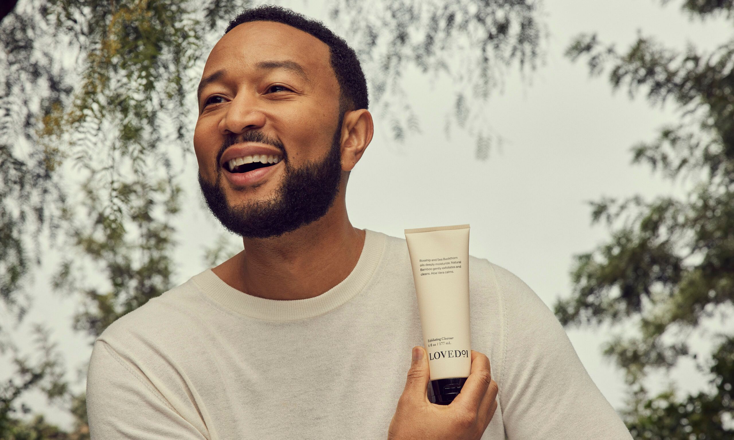 John Legend holding a LOVED 01 product