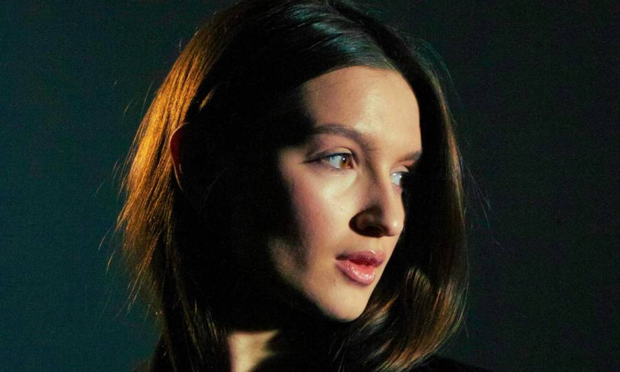brown haired woman in front of black background