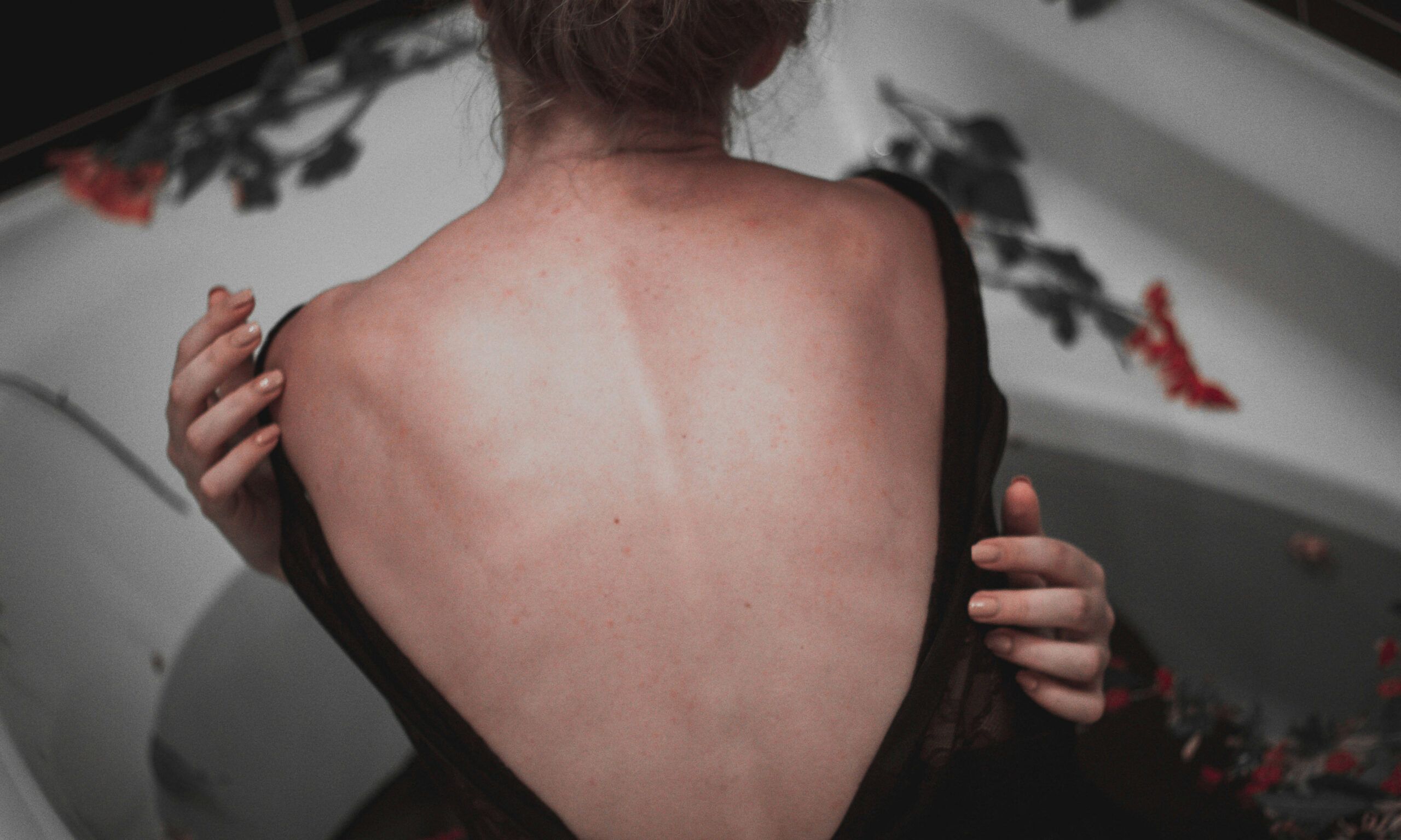 Girl holding herself with bare back exposed