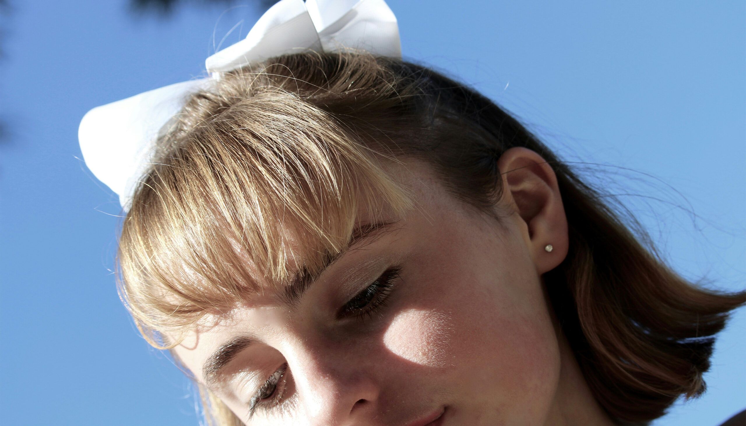 woman with bangs and bow