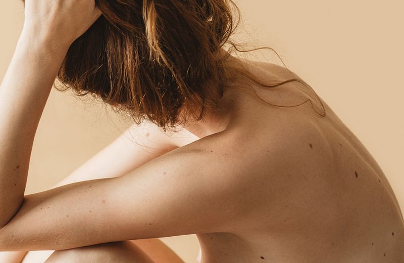 back of bare-skinned woman