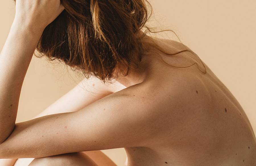 back of bare-skinned woman