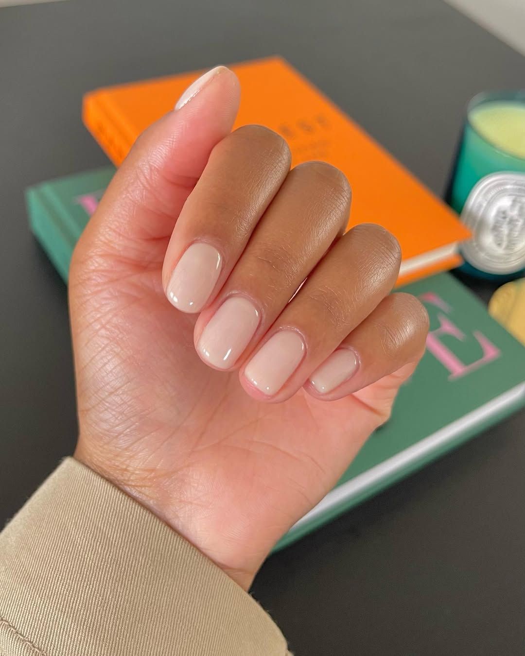Hands with a short nude manicure