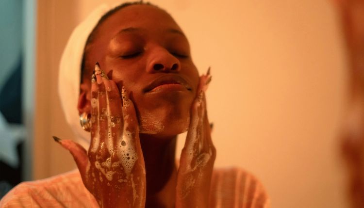 woman washing her face
