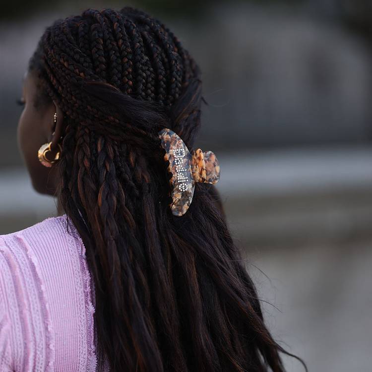 Back view of woman with long braids and claw clip hairstyle