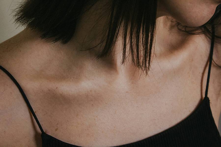 woman in black tank top. Focus on chest