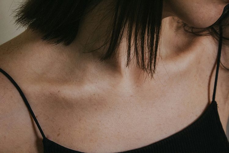 woman in black tank top. Focus on chest
