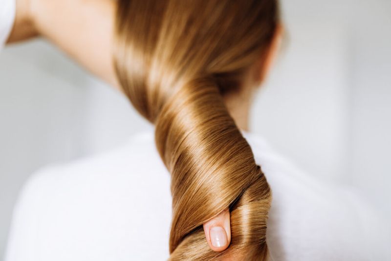 blonde hair twisted in hand