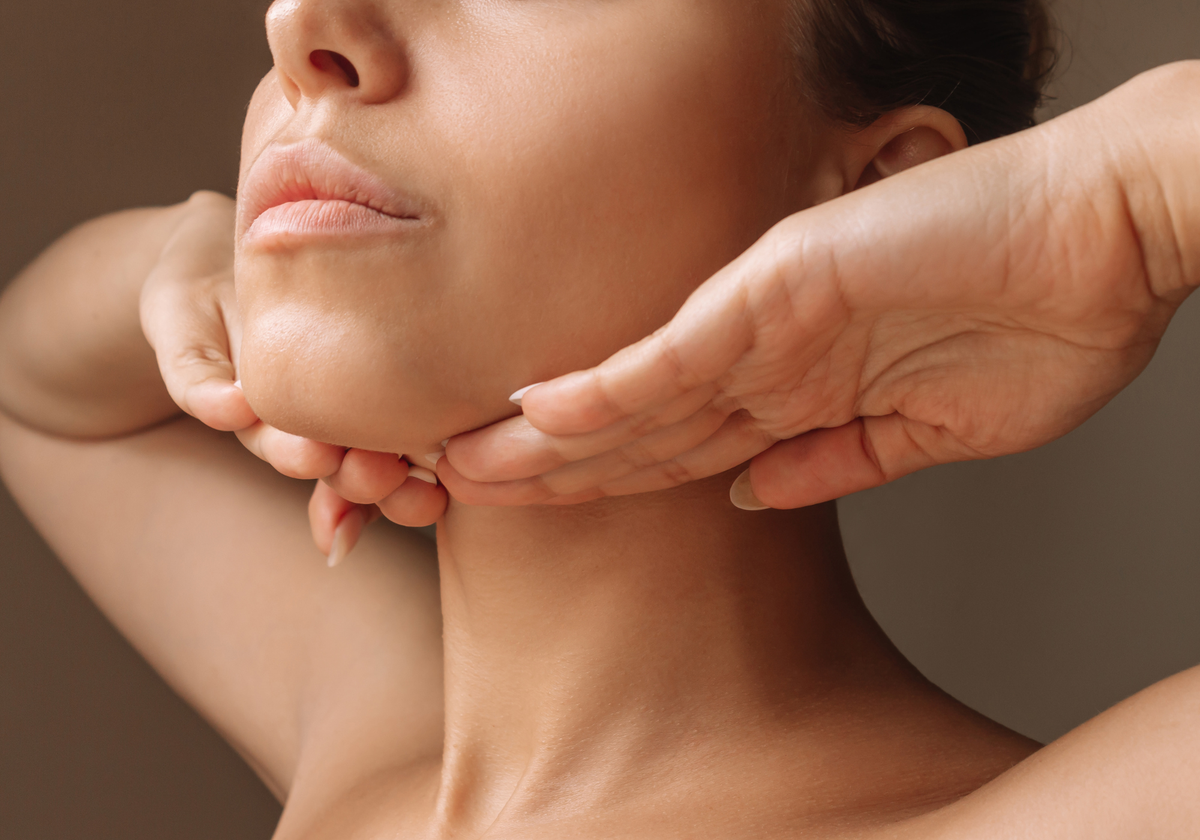  Young woman touching under the chin
