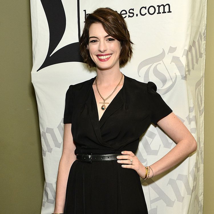 Anne Hathaway poses in a black dress