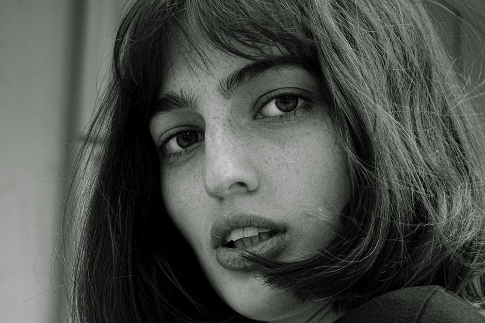 black and white photo of woman with bobs and bangs