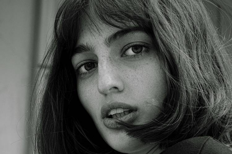 black and white photo of woman with bobs and bangs