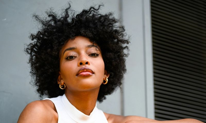 woman with afro looking up to camera