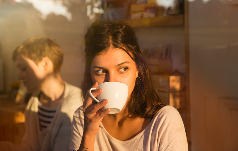 woman sipping from mug