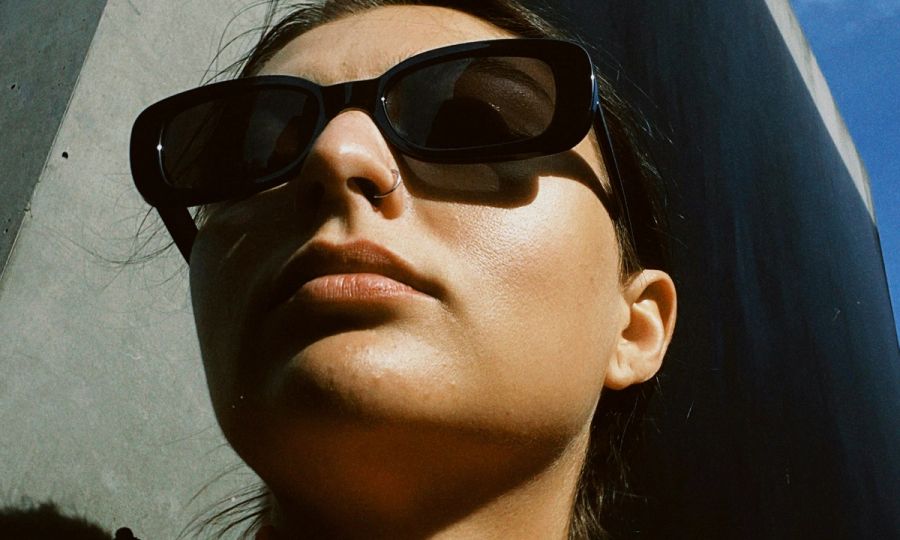 outdoor up shot of woman's face wearing sunglasses