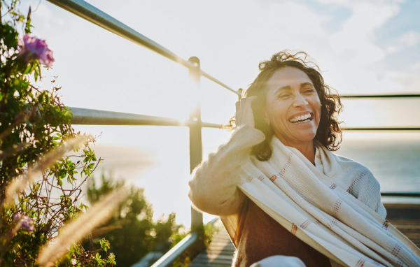 Confident middle-aged woman smiling outdoors