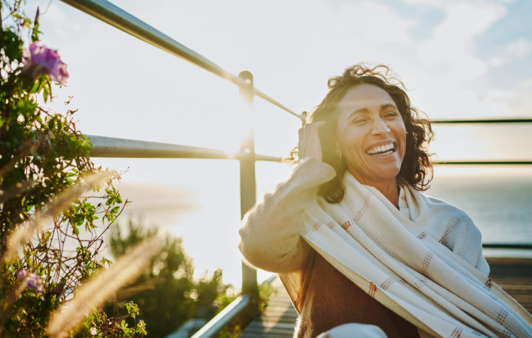 Confident middle-aged woman smiling outdoors