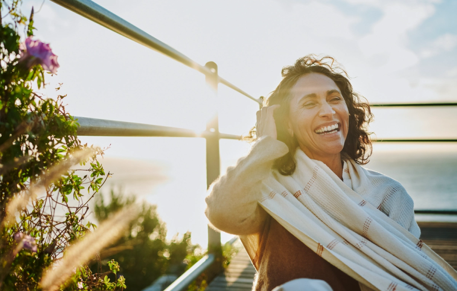Confident middle-aged woman smiling outdoors