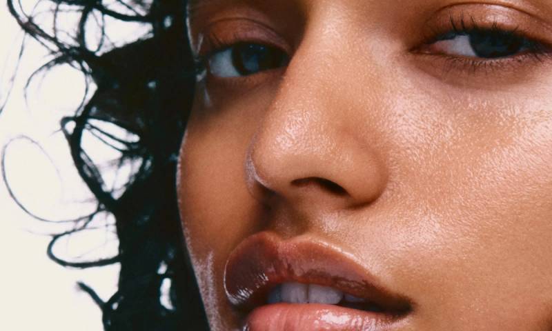 close photo of woman's misted skin