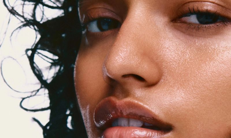 close photo of woman's misted skin