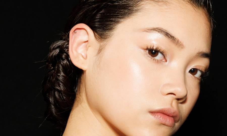 Up-close of Asian woman's face on a black background