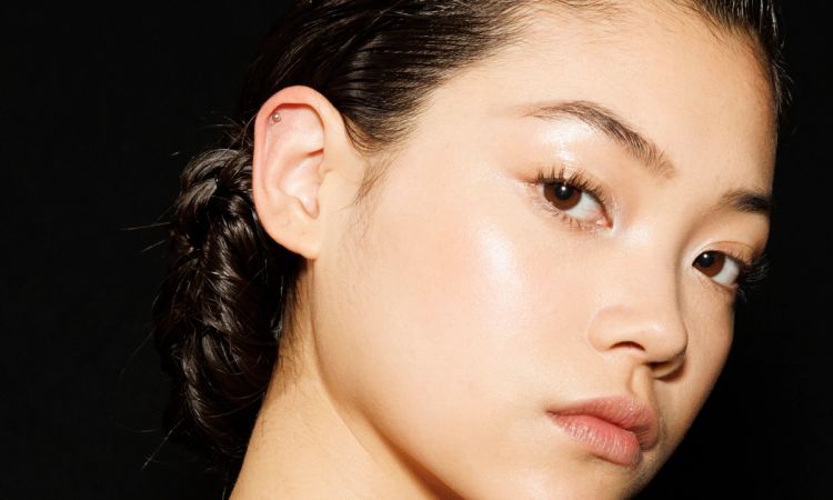 Up-close of Asian woman's face on a black background