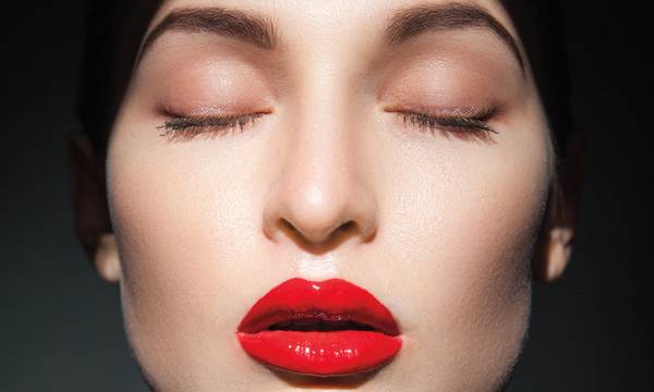 woman with closed eyes in shadows wearing red lipstick