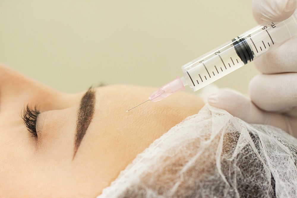 Woman at the beautician. The concept of injection cosmetology, anti-aging procedures.