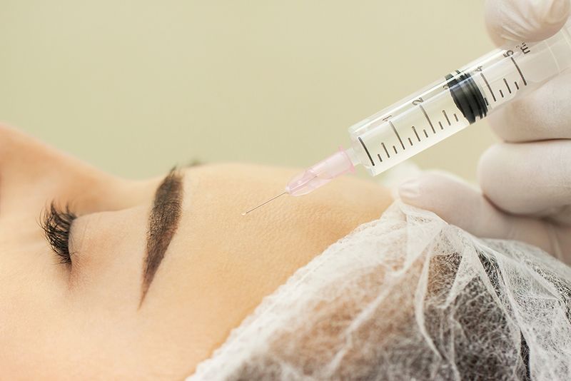 Woman at the beautician. The concept of injection cosmetology, anti-aging procedures.