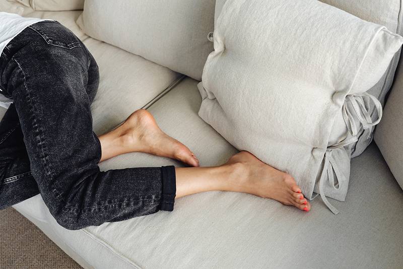 woman's feet on couch