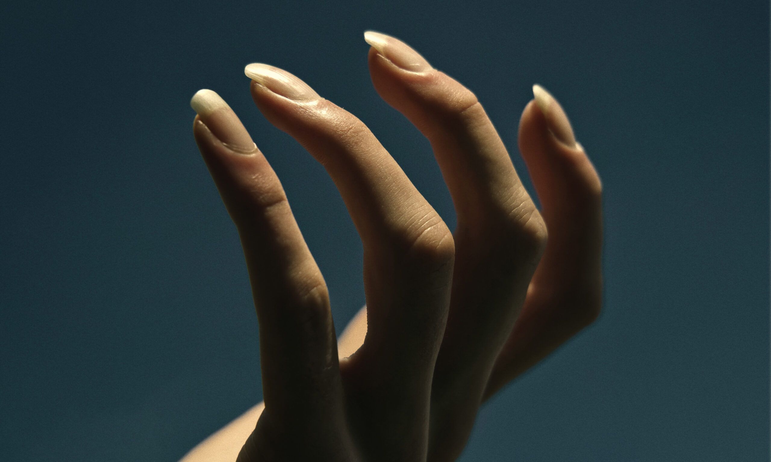 hand against a dark background