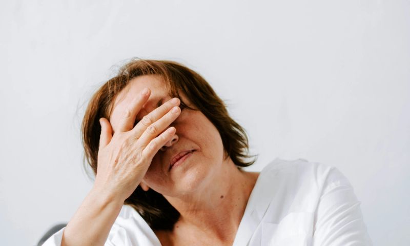 older woman with hands on her face