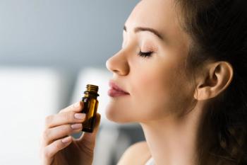 woman smelling essential oils