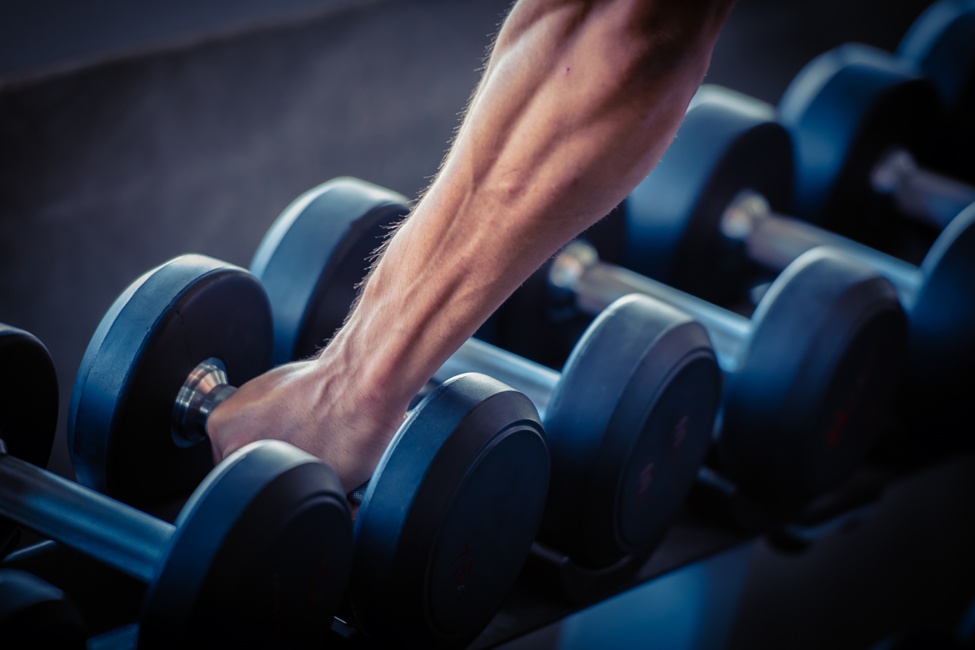 arm picking up dumbbells
