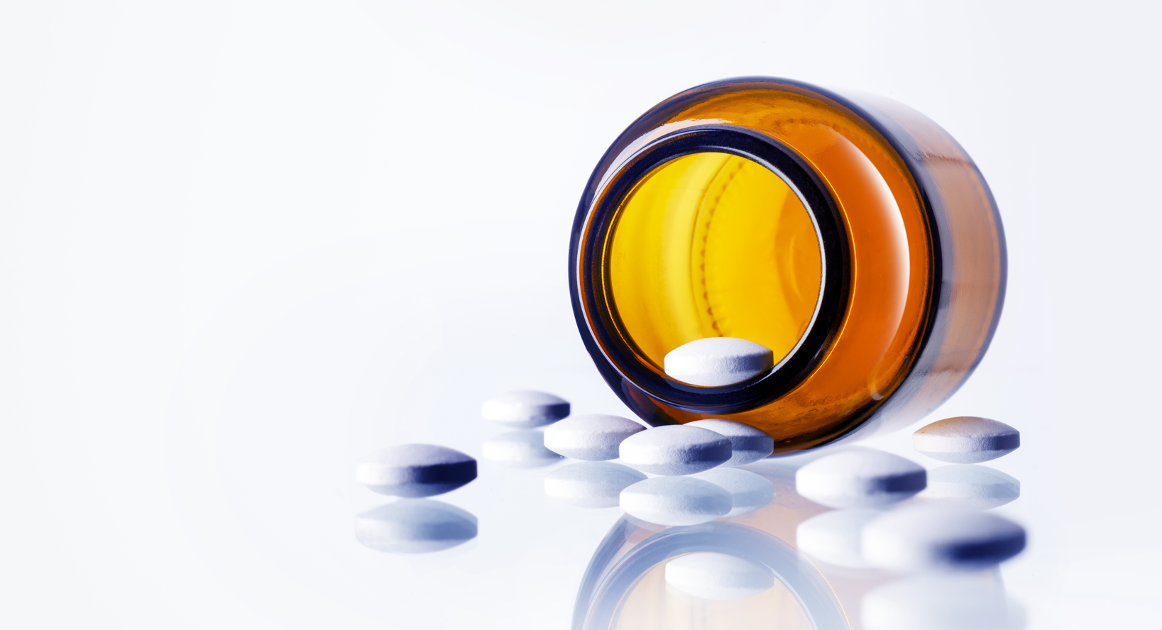 bottle turned over, spilling white pills