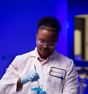 scientist mixing solution in beaker