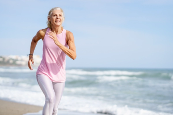 older woman running on the beach