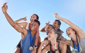 athletes smiling for a selfie