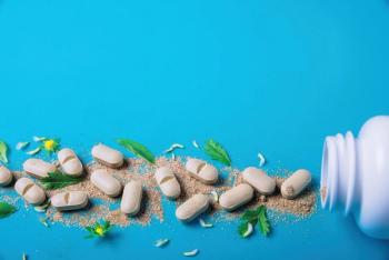 herbal supplements poured out on blue background