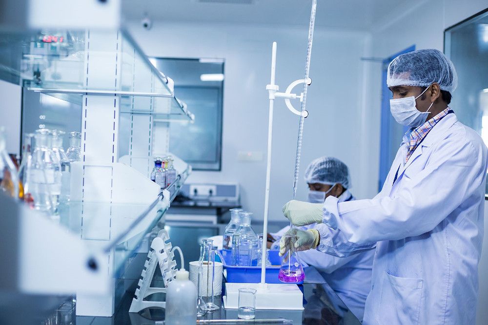 workers in lab wearing personal protective equipment